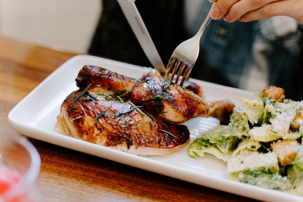 Half a roast chicken with topped with rosemary, accompanied with broccoli and pumpkin. An easy yet tasty white over red meat option.