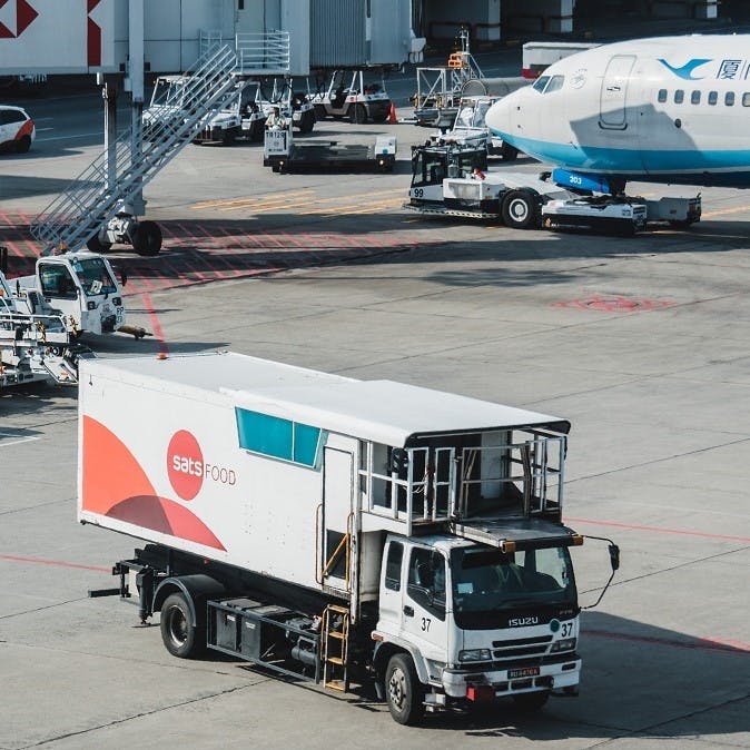 A food delivery lorry at an airport. Airports are one place that definitely need to learn how to reduce food waste.