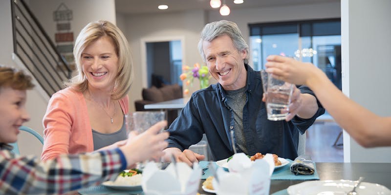 family celebrating biweekly mortgage payments at dinner