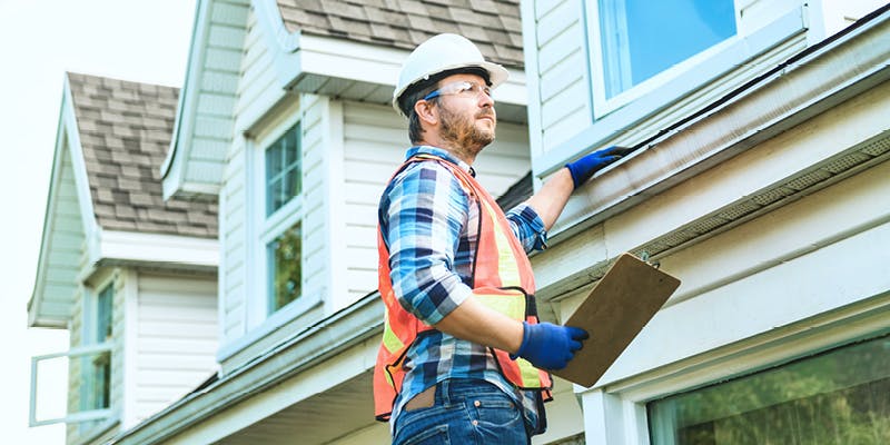 A contractor repairing roof after home inspection