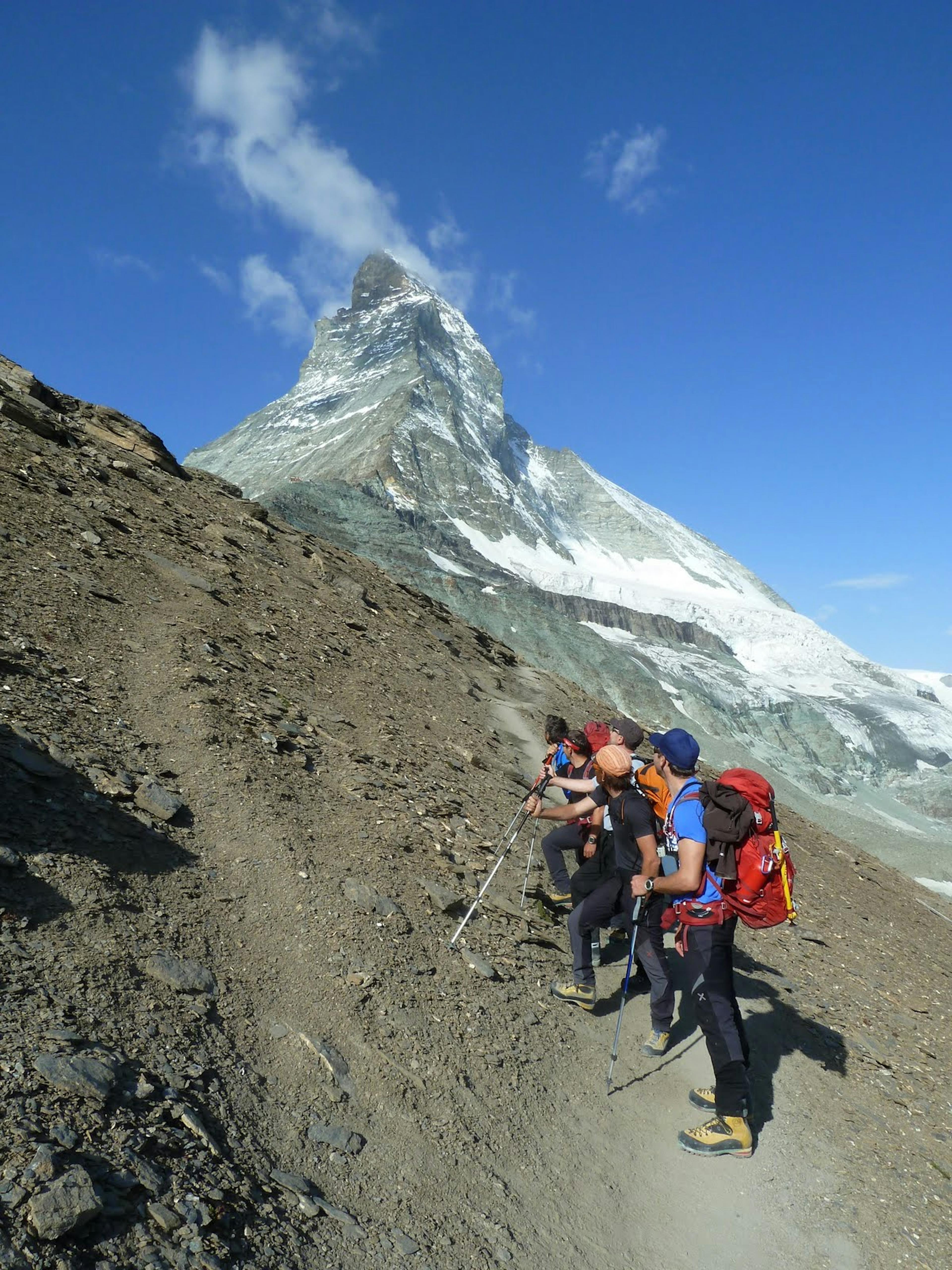 a group hiking to the hornli hut and looking at the matterhorn