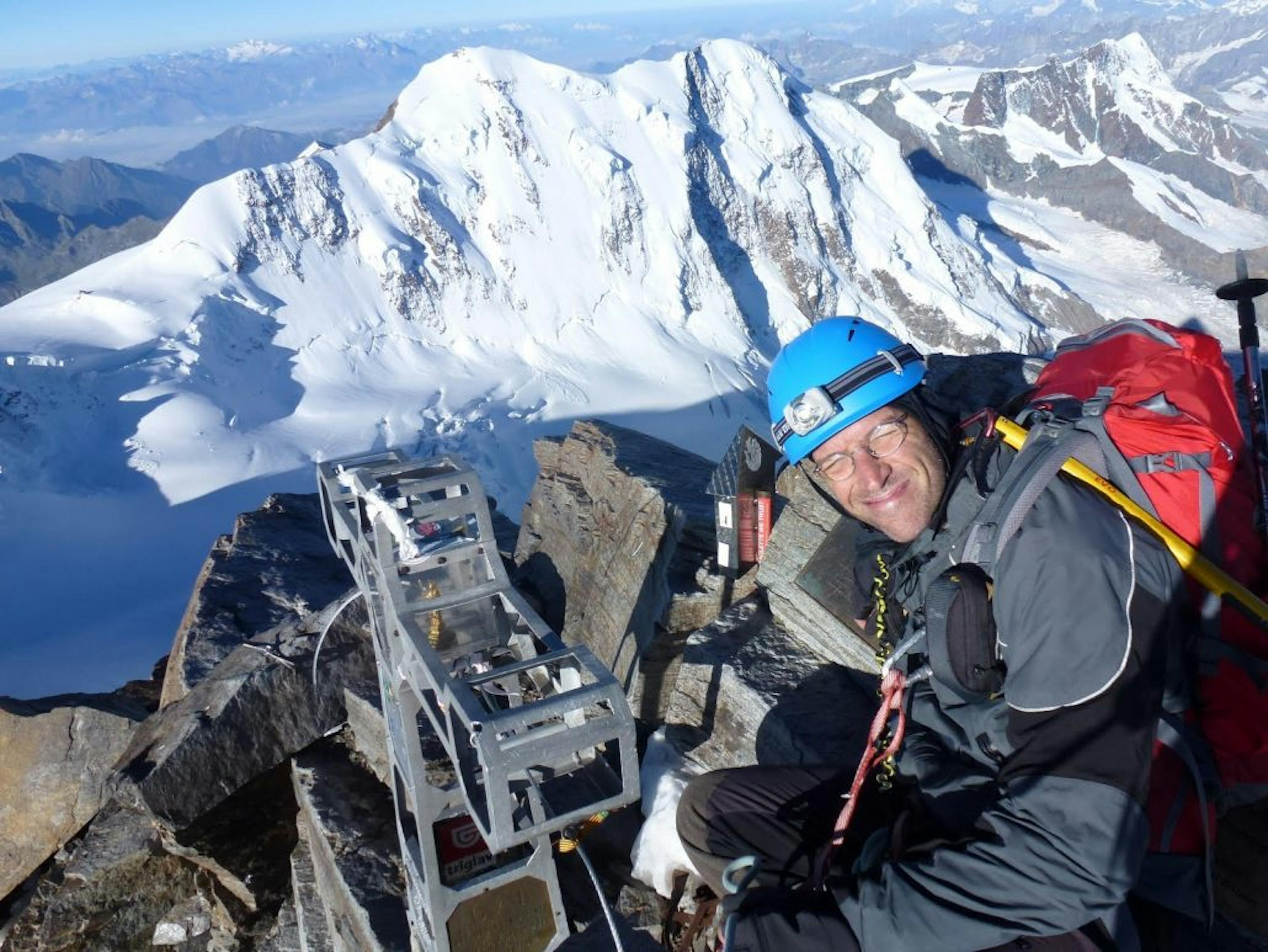 a man standing on the summit of Dufourspitze