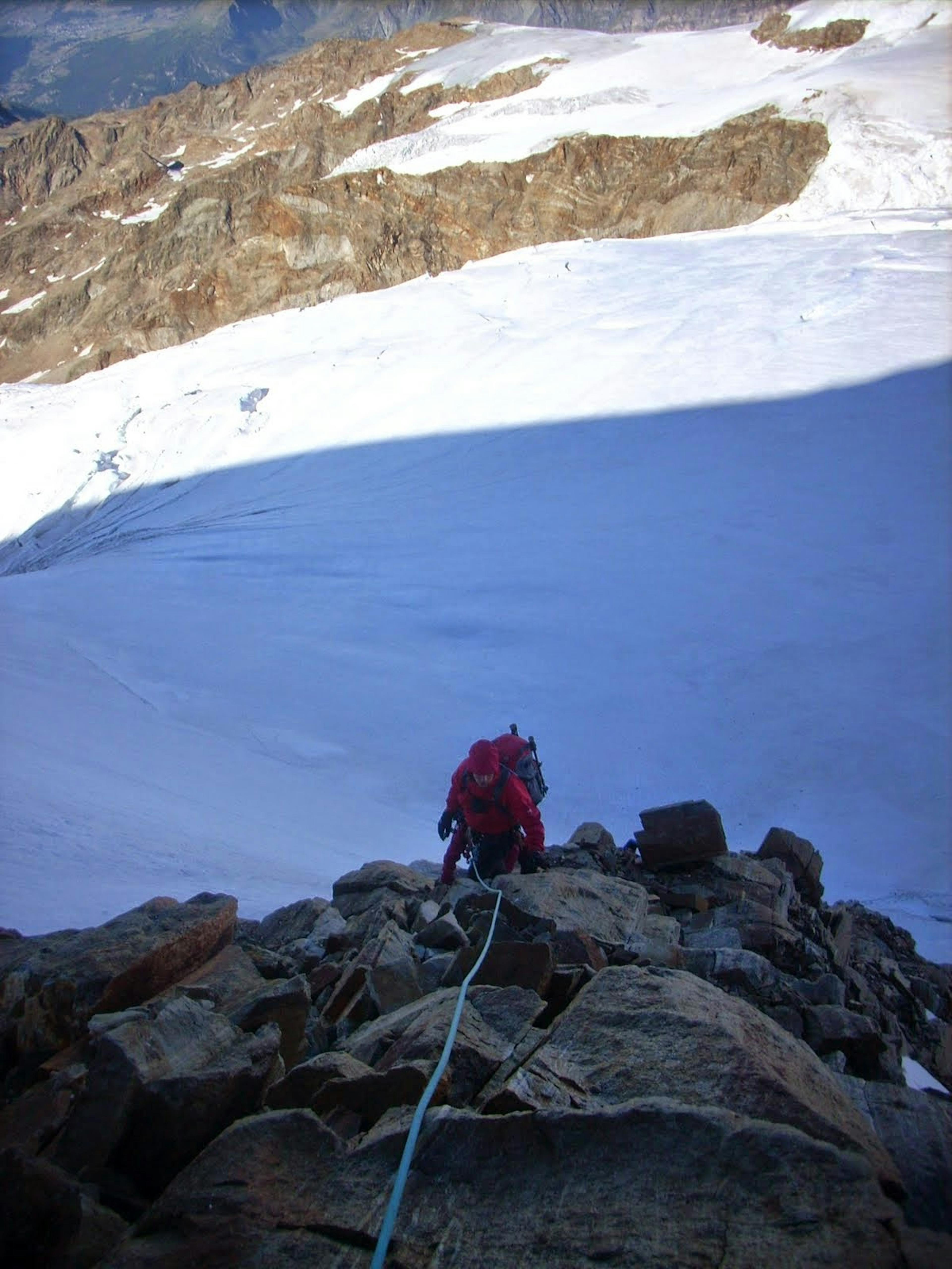 a man climbing the ridge of the Lyskamm nose