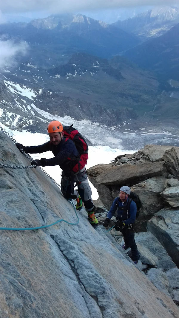 a man climbing the fixed ropes of the Pollux