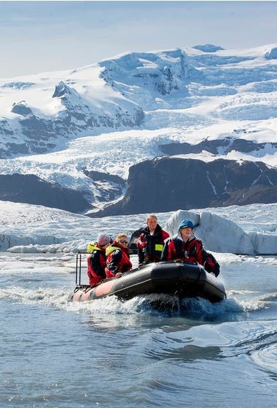 people sailing through the glacier lagoon of Vatnajokull