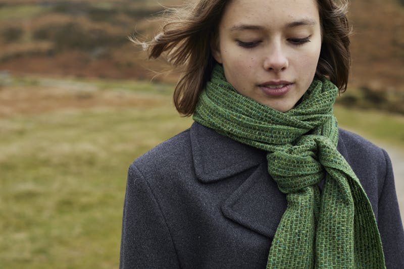 woven Green scarf on girl in mountain landscape