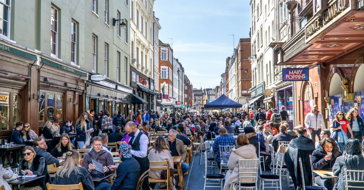 London, UK - 18 April 2021: Outdoor drinking and dining outside pubs on Old Compton Street, Soho, central London