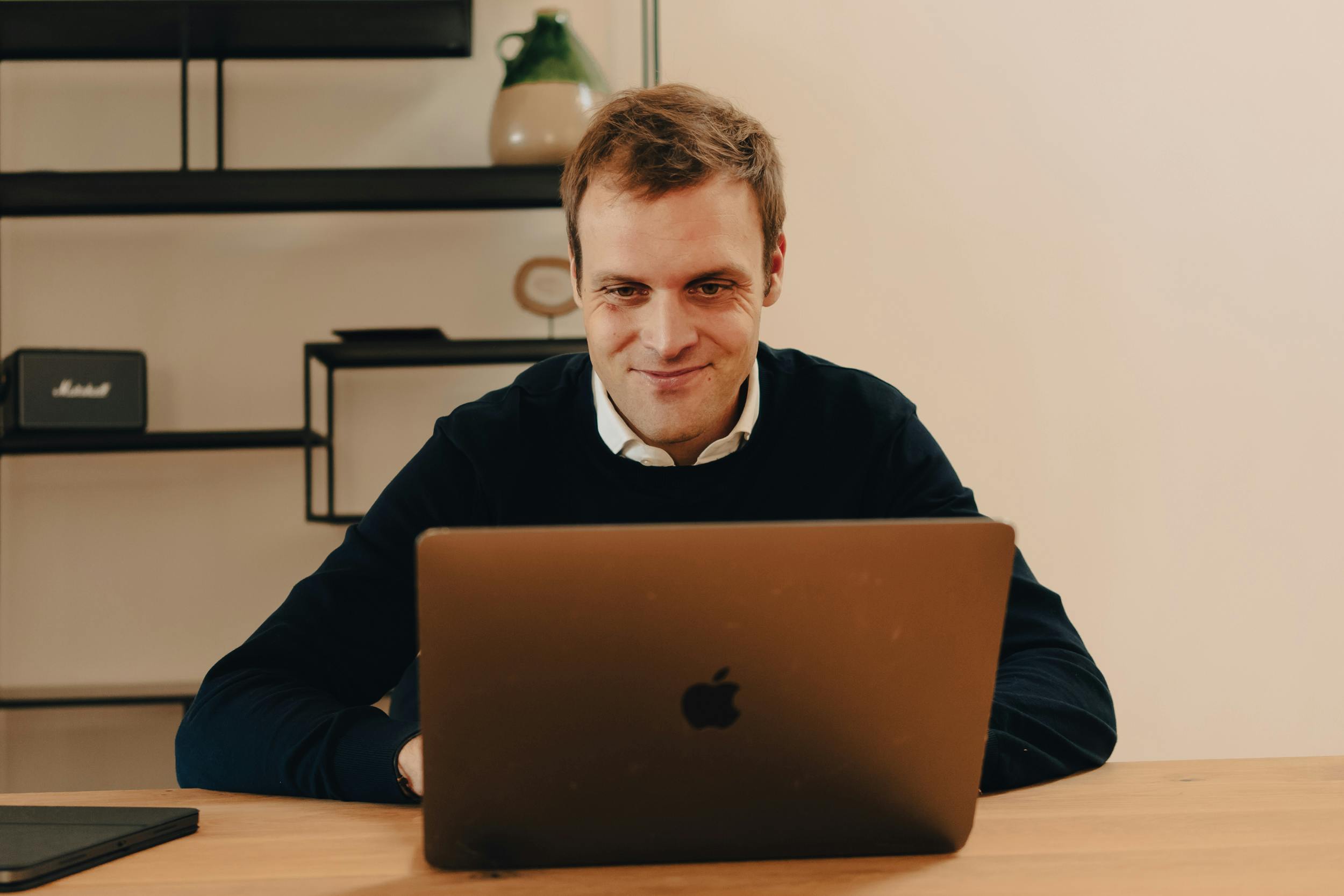 Man smiling at his laptop