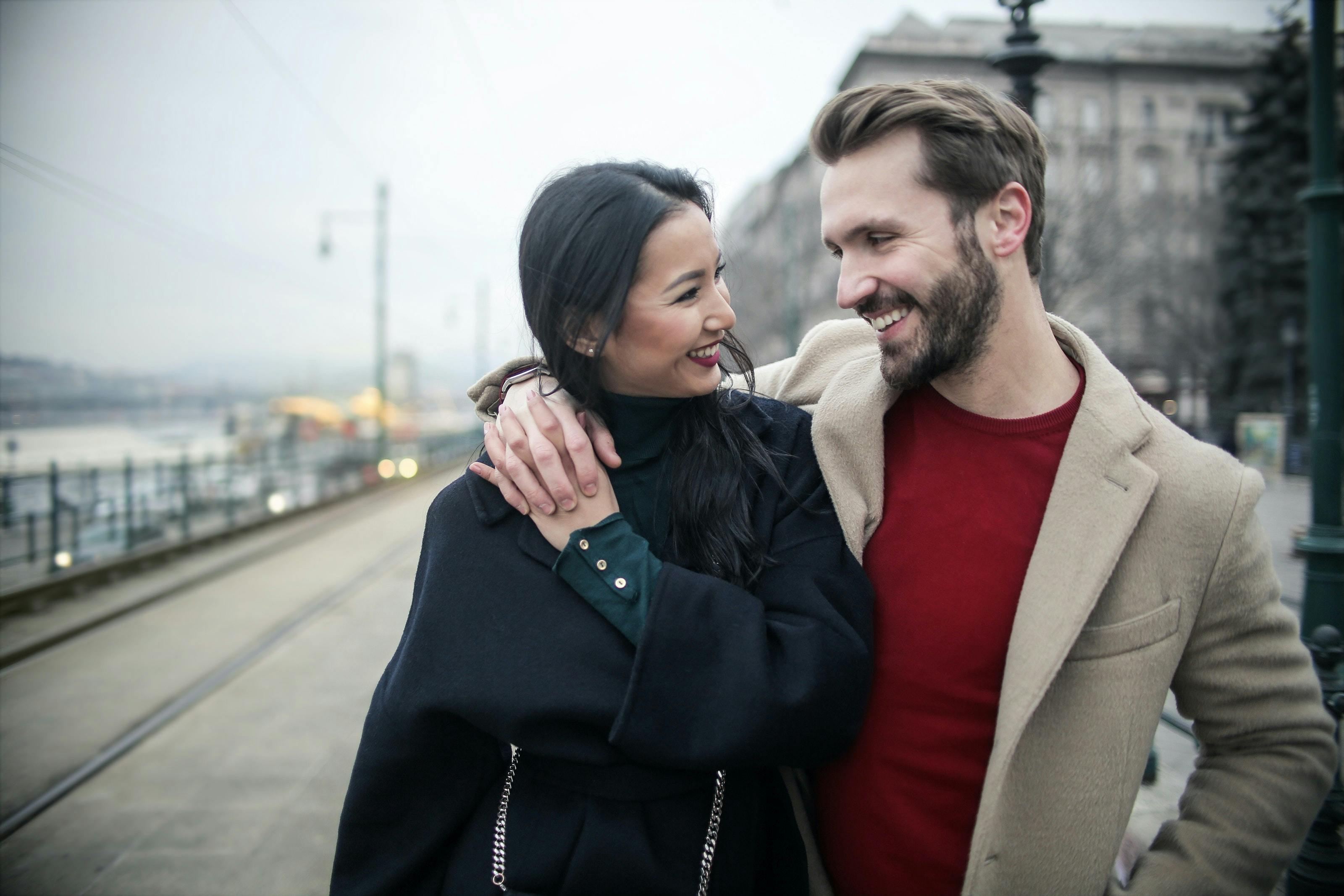 Couple holding hands, looking at each other and smiling