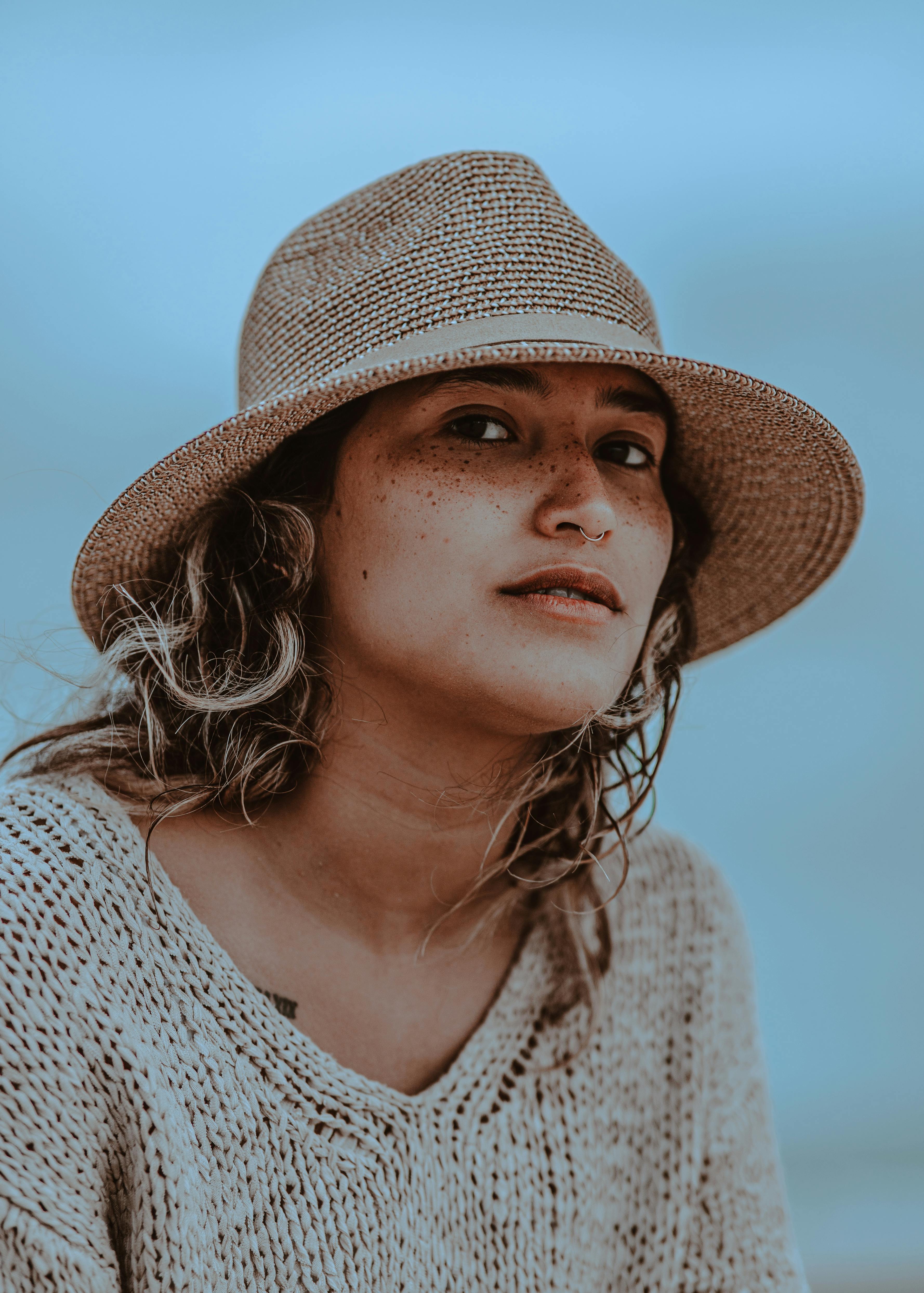 young woman with a straw hat on the beach