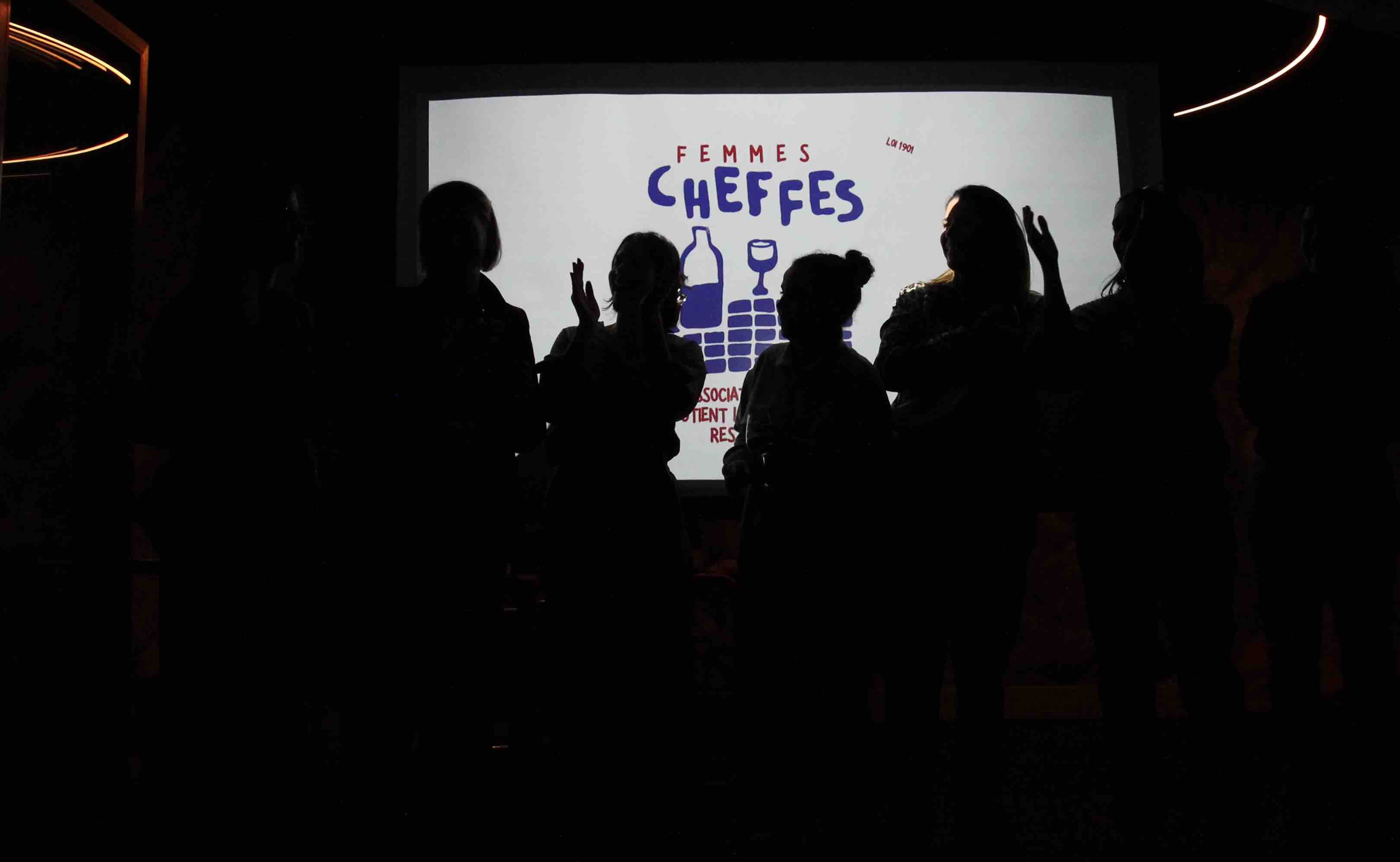 ombre de femmes sur projection logo