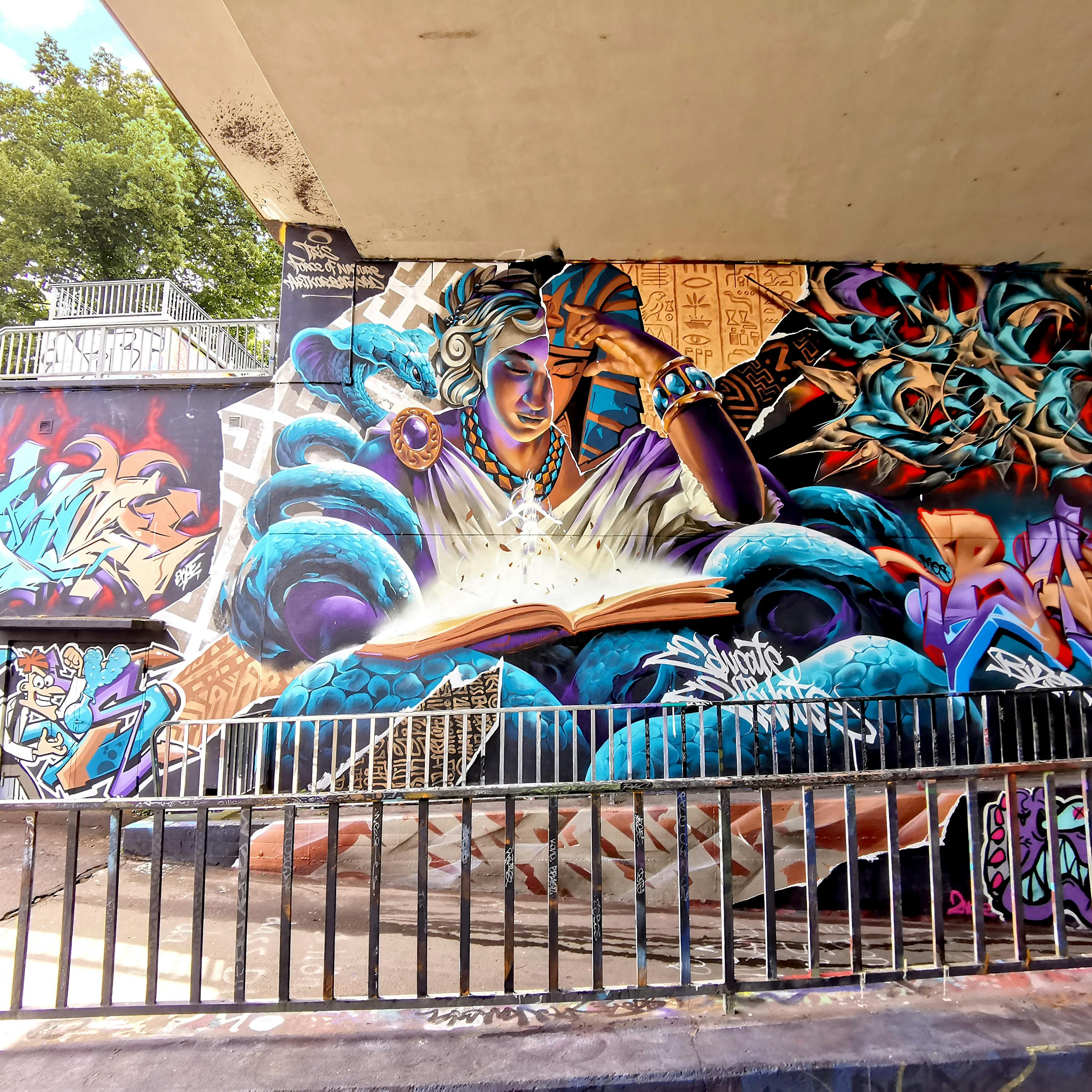 Mural painting Wiesbaden, Meeting of styles, Force of Nature (GER), ArtkorBagdad(FR), Tris (FR), a woman reading a book, snake