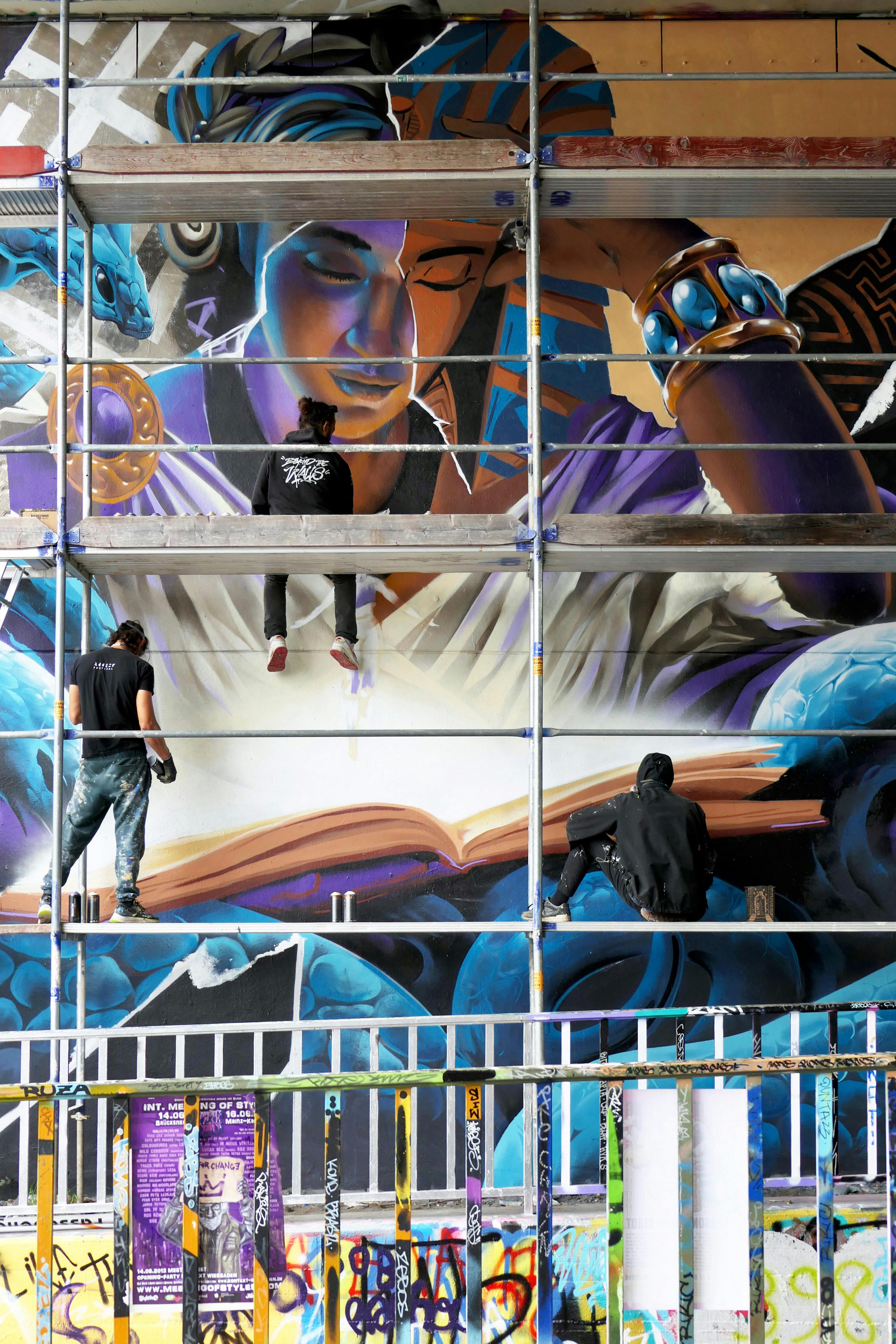 Work in progress mural painting Wiesbaden, Meeting of styles, Force of Nature (GER), ArtkorBagdad(FR), Tris (FR), a woman reading a book, snake