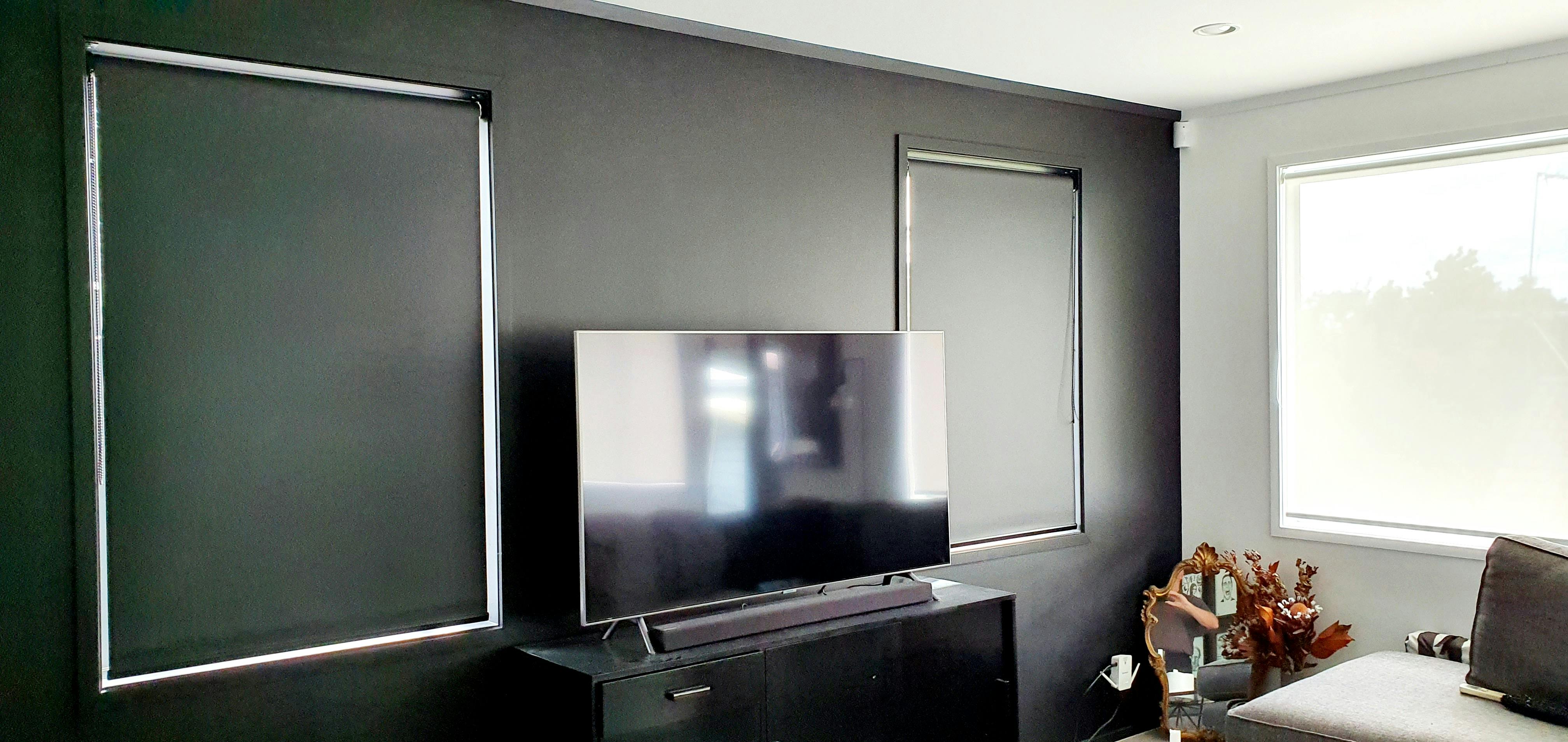 An additional Lounge/tv room with combination of blackout blinds and sunscreen blinds, black and white blind combo.