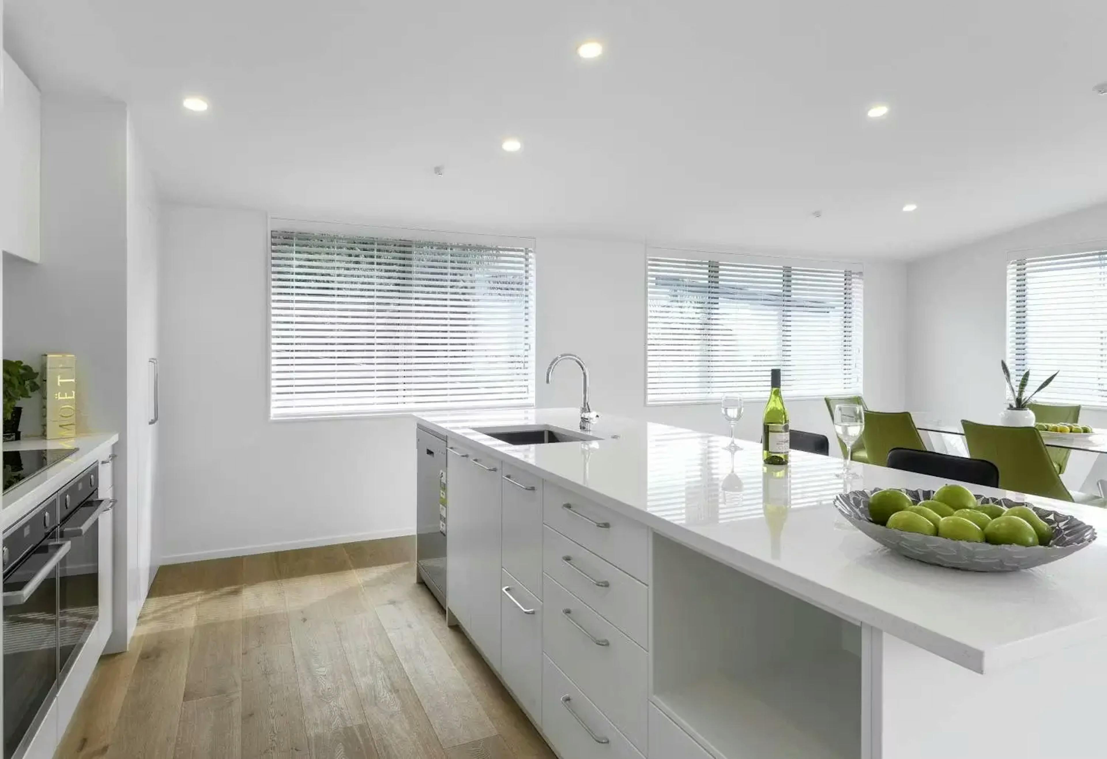 Kitchen windows with white blinds