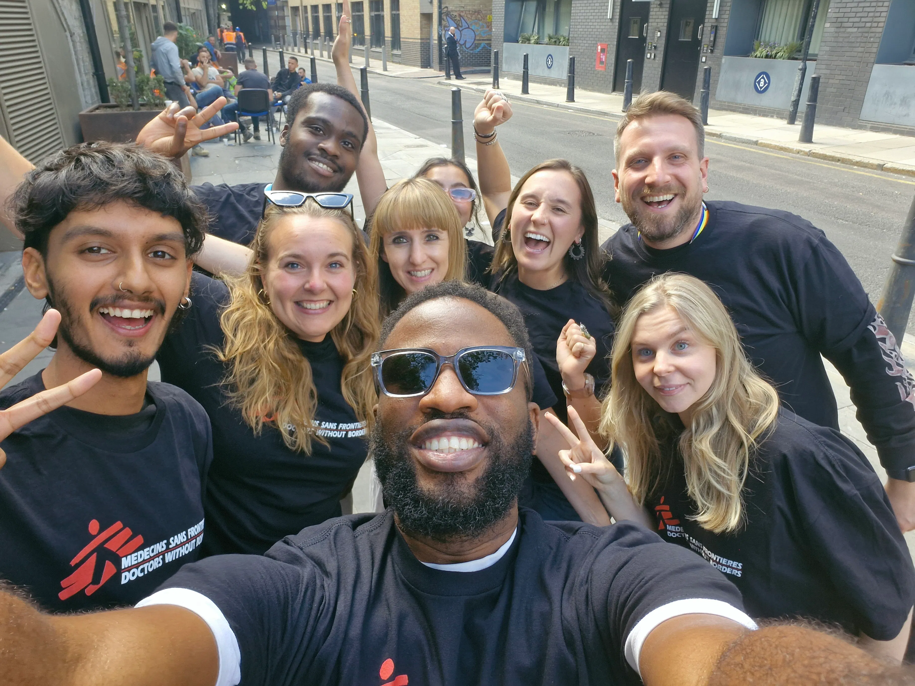 A group of smiling people wearing MSF t-shirts