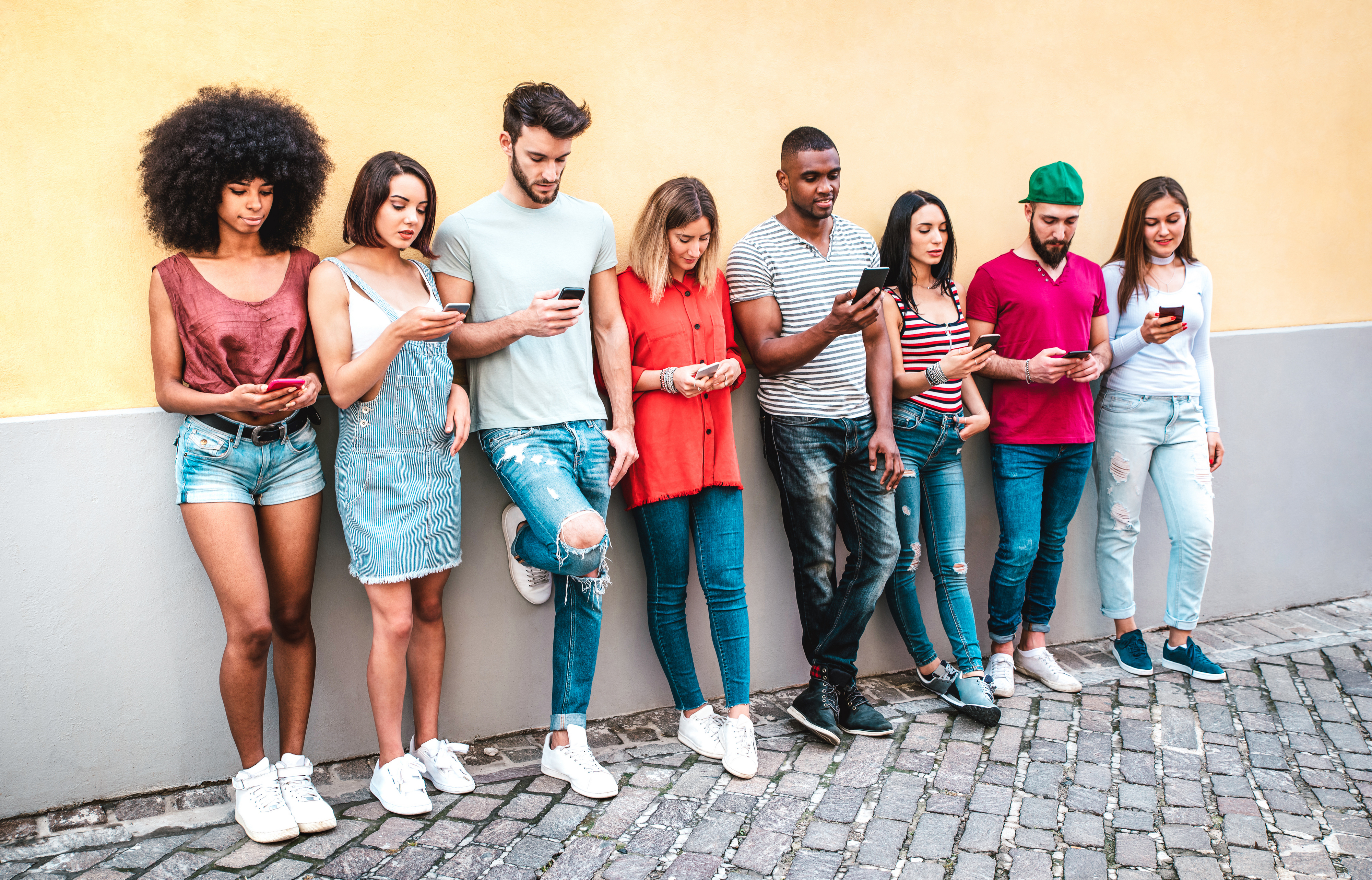 Multicultural millennials using smartphone against a white background