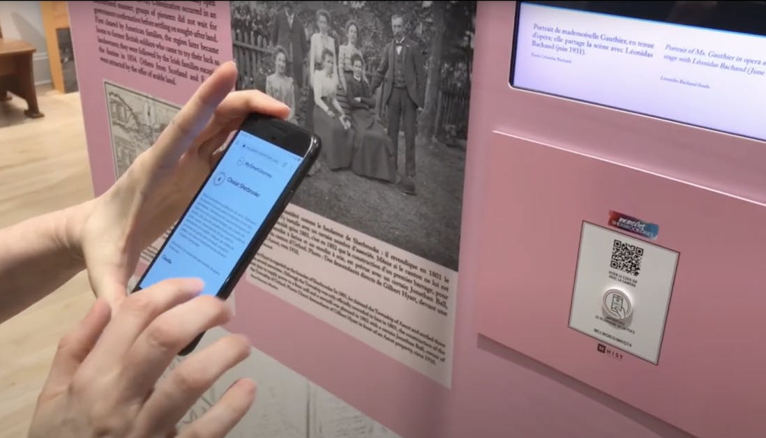 A person scans a QR code at the Sherbrooke History Museum