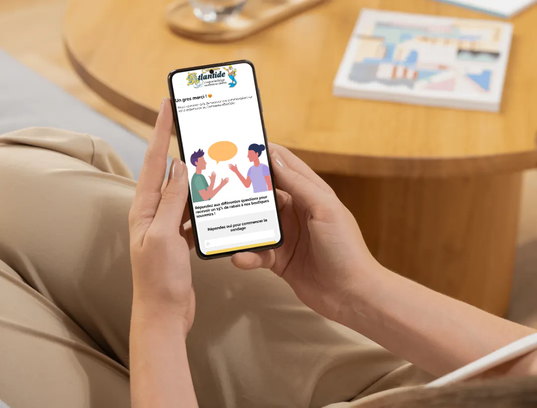 Personne regardant le contenu du Complexe Atlantide sur son téléphone avec