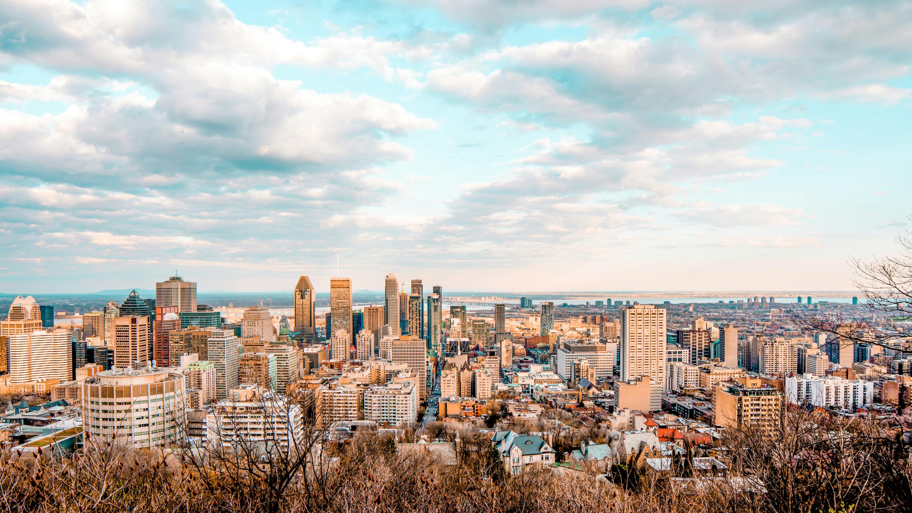 City of Montreal cityscape with blue skies and Leonard Cohen Mural