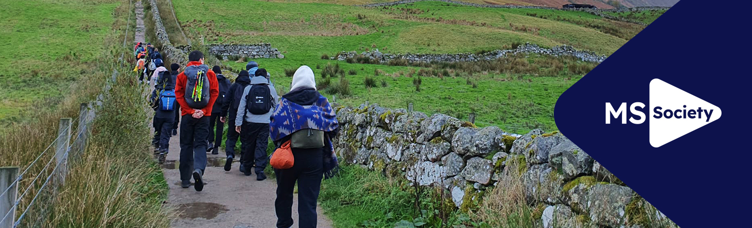 MS Society corporate hub banner with participants taking part in a charity walk in nature.
