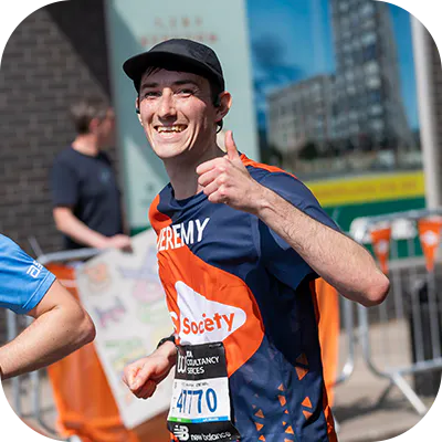 Charity runner giving a thumbs up.