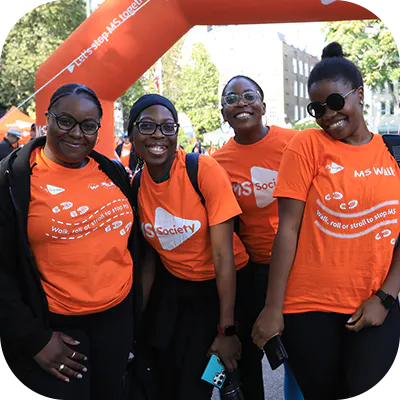 Charity walkers smiling in MS Society t-shirts.