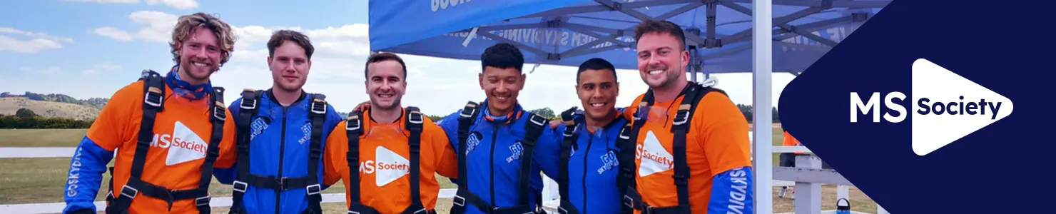 MS Society corporate hub banner with charity event participants smiling arm-in-arm wearing MS Society tops.