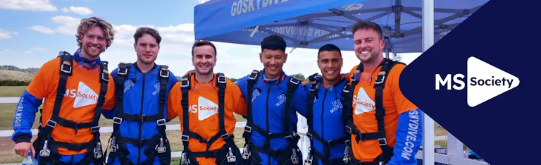 MS Society corporate hub banner with charity event participants smiling arm-in-arm wearing MS Society tops.