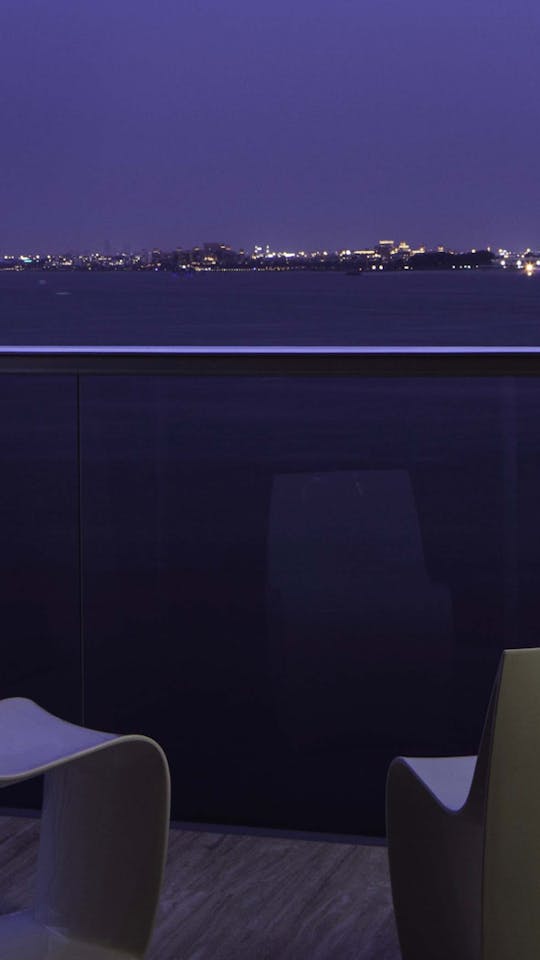 Contemporary terrace with a view of the Dubai bay landscapes by night