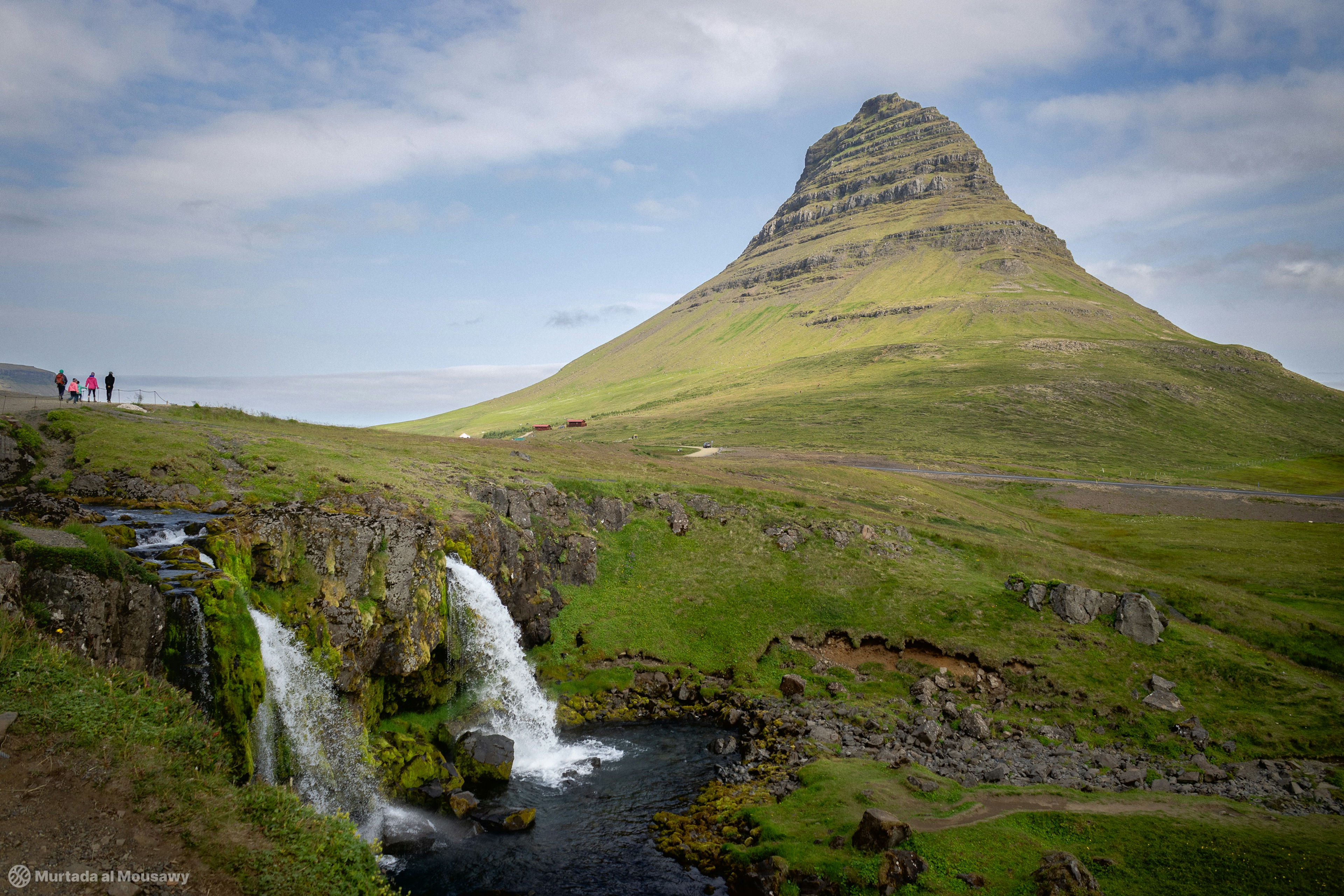 Photo of the famous Kirkjufell mountain with waterfalls in the foreground.