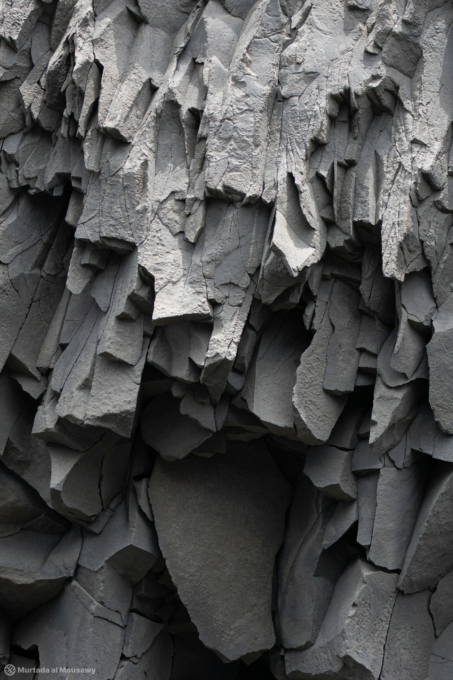 Photo of basalt columns hanging in a cave in Iceland.