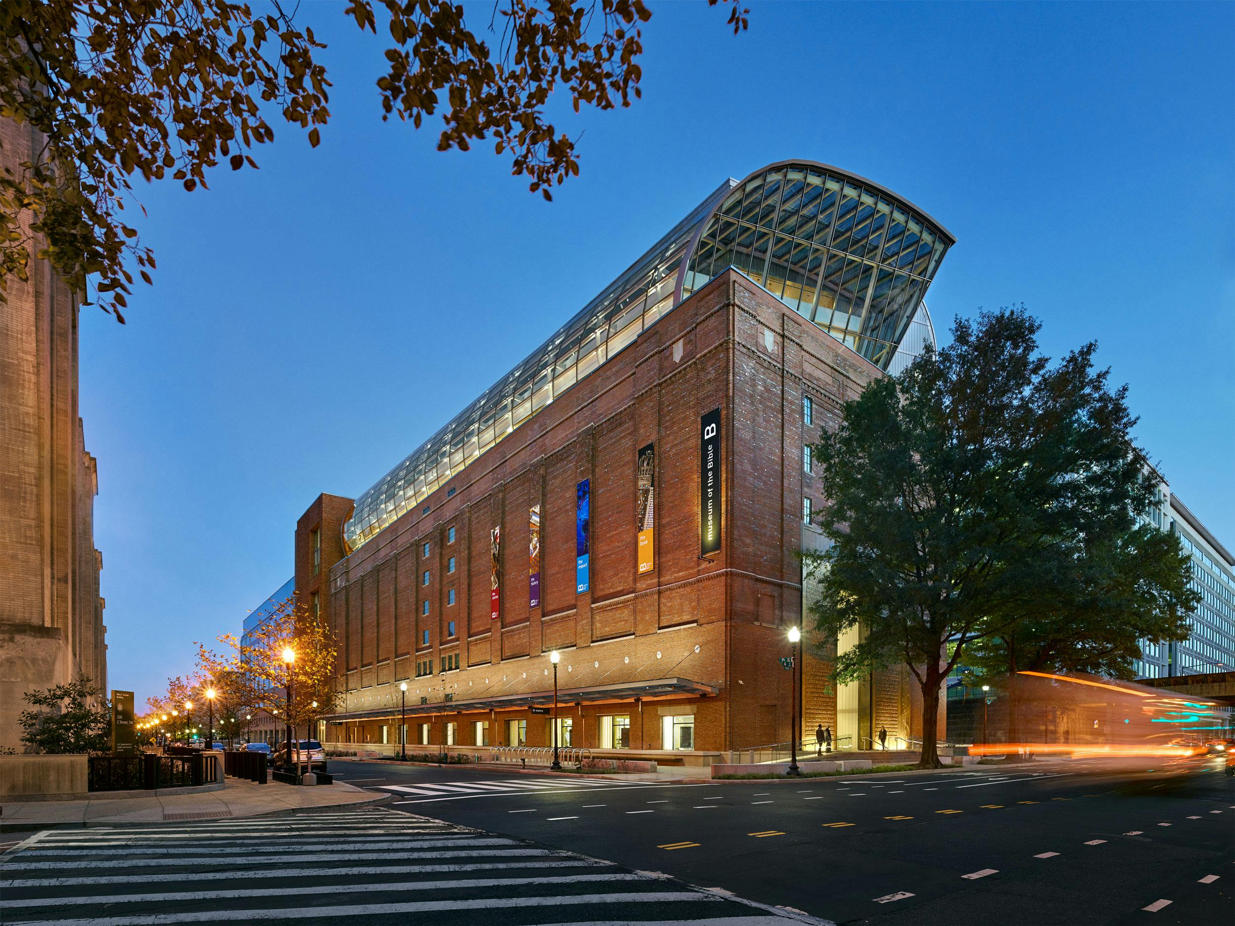 Exterior evening view of Museum of the Bible from the corner of 4th Street SW and D Street SW in Washington, D.C.