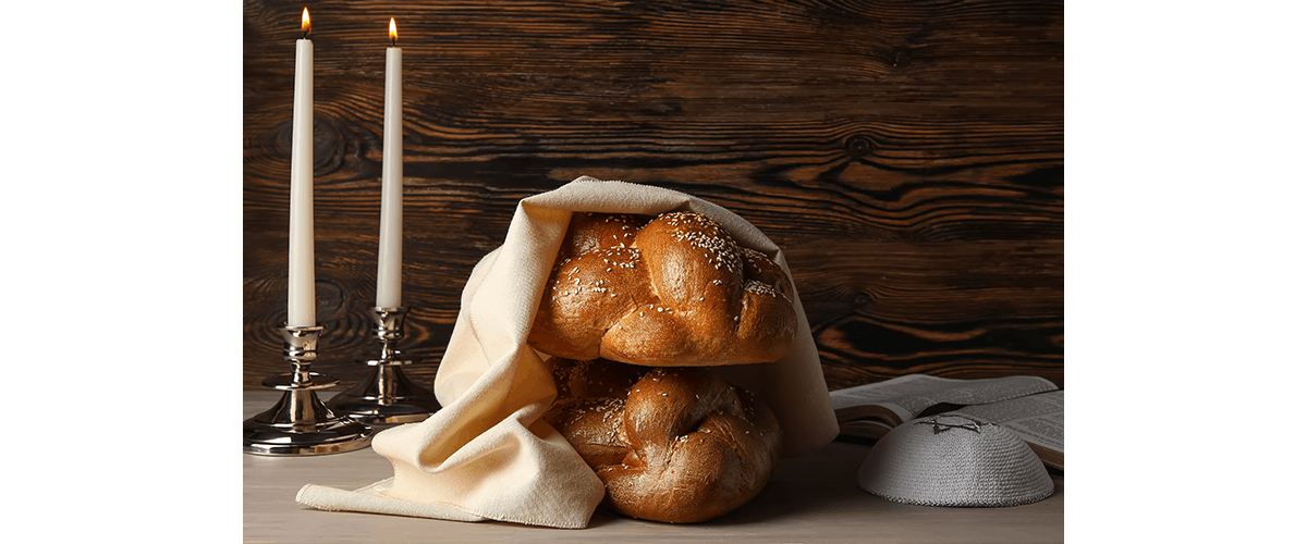 Two challah loaves on a Shabbat table