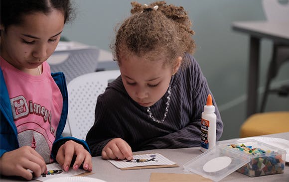 Two girls working on mosaic art
