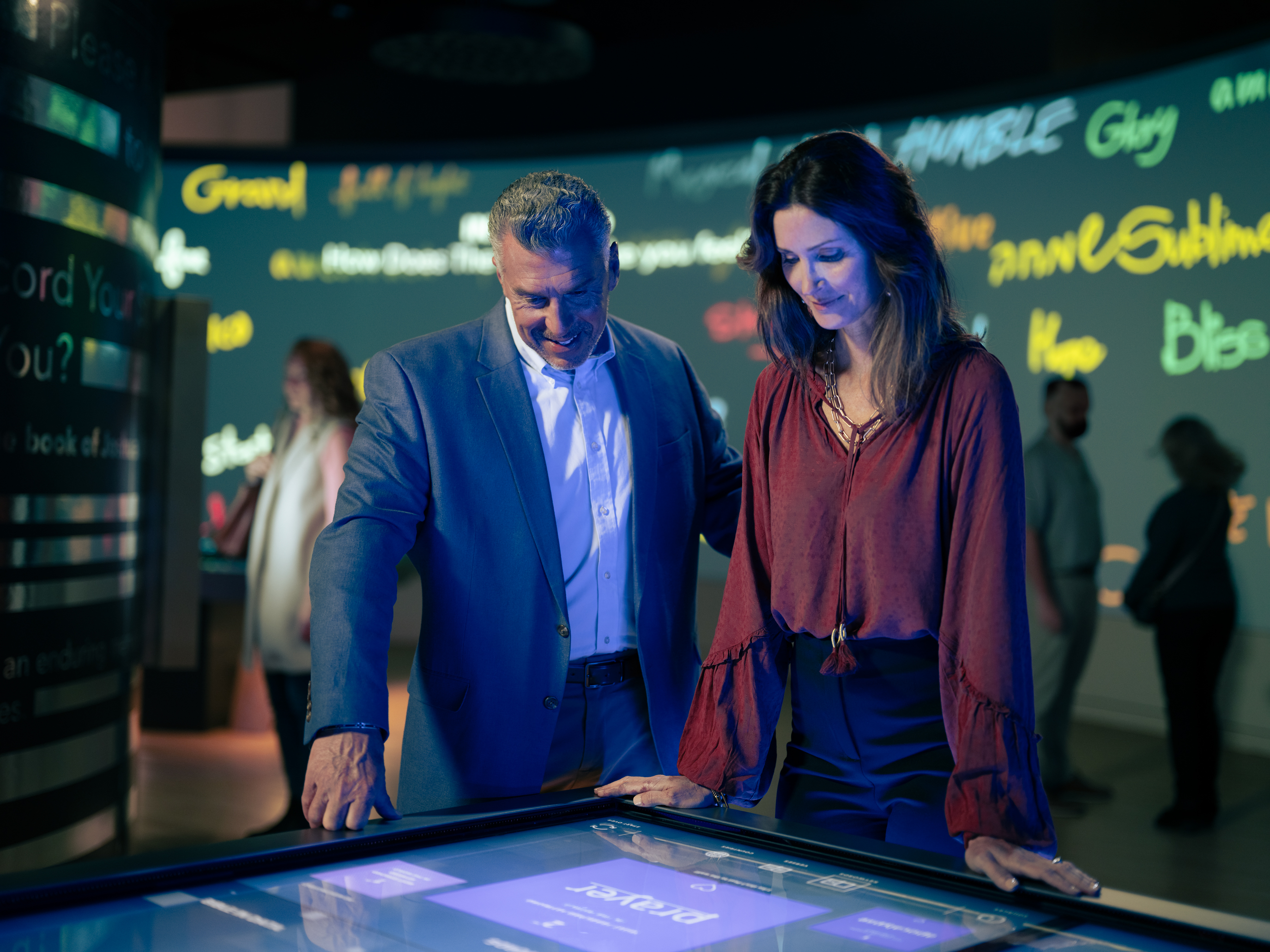 Couple interacting with a display on the Impact floor.