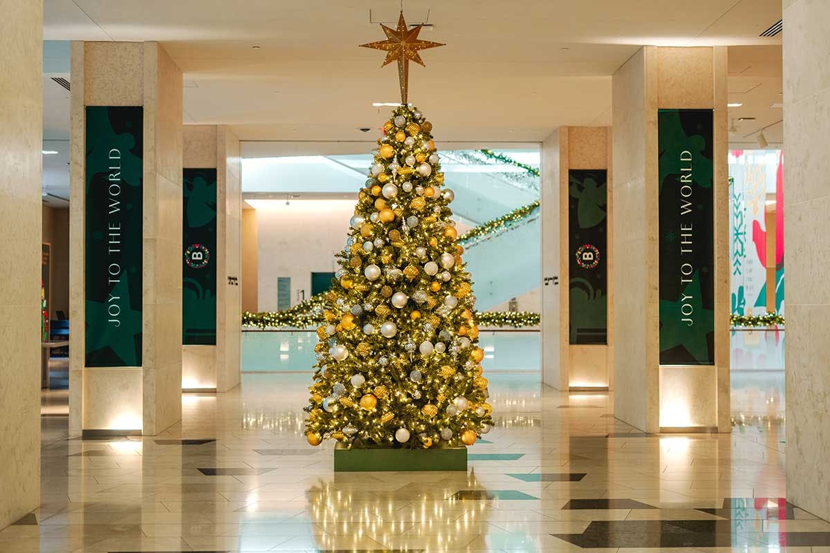A Christmas tree decorated in gold and silver in the Grand Hall of Museum of the Bible.