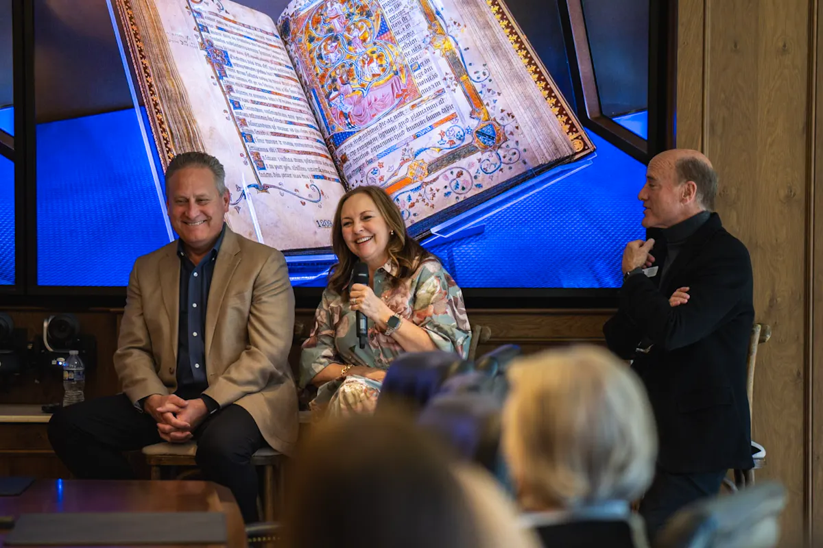Steve and Jackie green on stage with Carlos Campo at the 2024 Summit and Reunion.