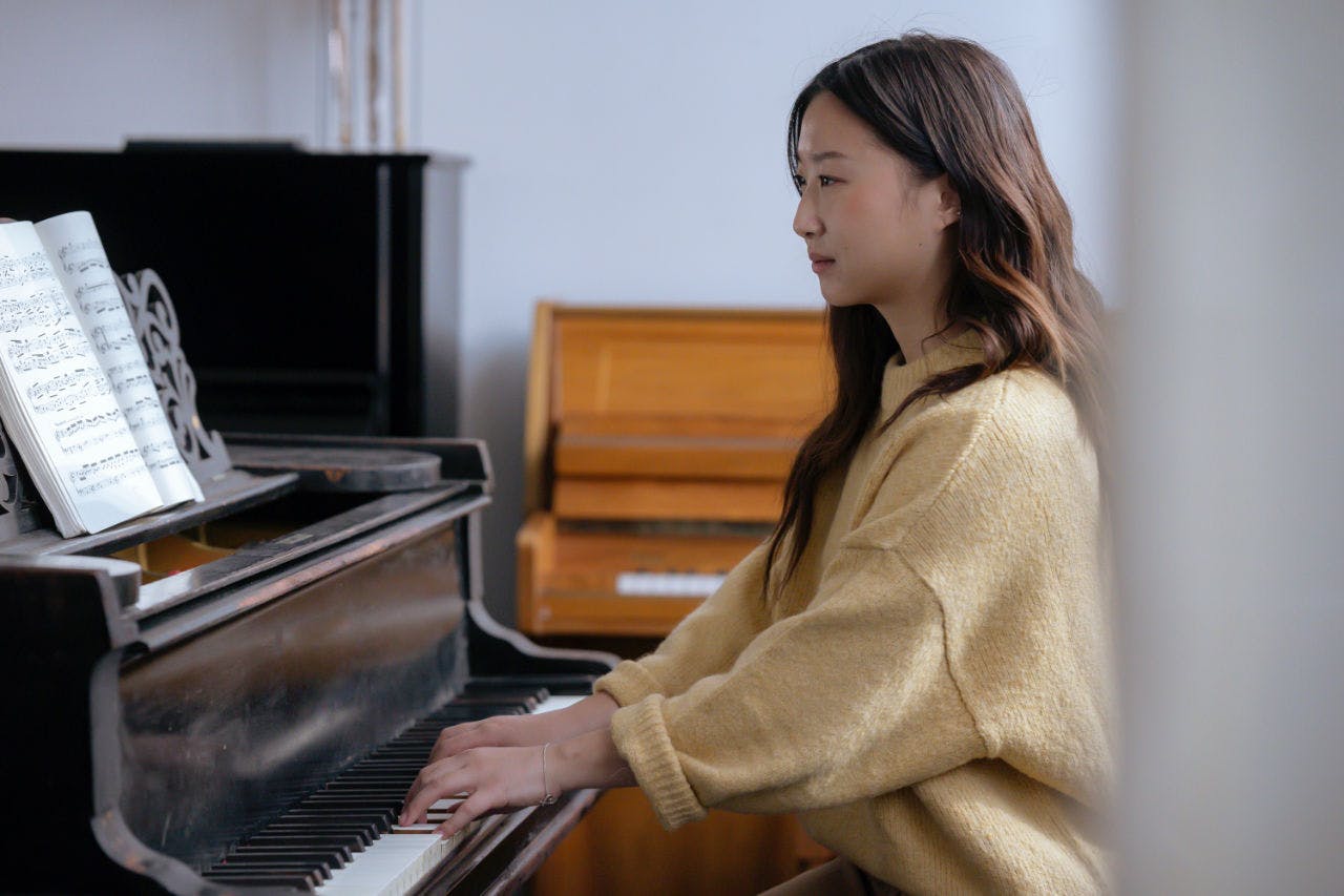 A Girl Learning How to Play the Piano