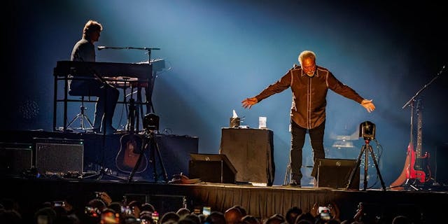 Paddy Milner on stage with Sir Tom Jones