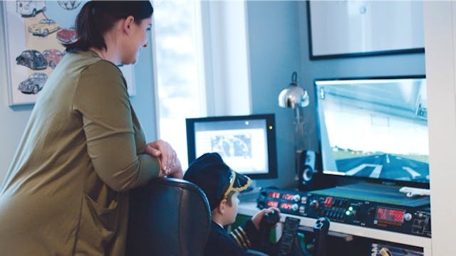 Aleksander prepares for take off in his flight simulator every day