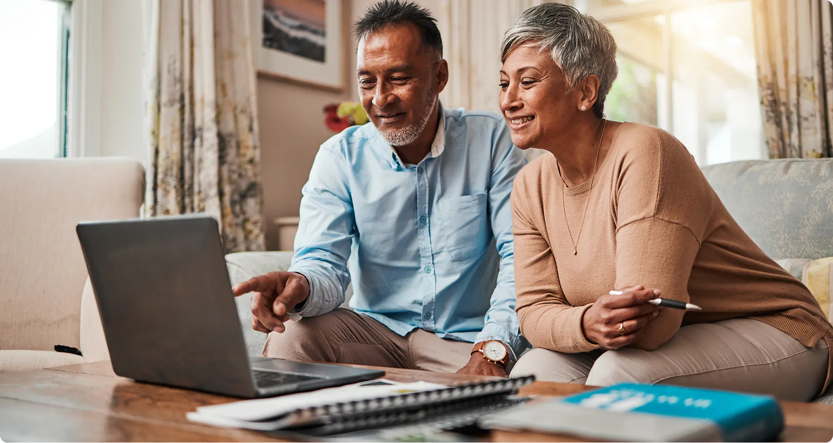 older couple searching on laptop for cms vs medicare.org