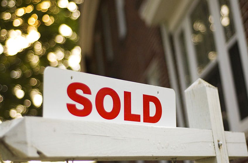 Sold sign in front of house