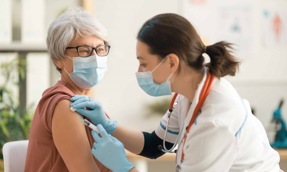 Doctor administering shot