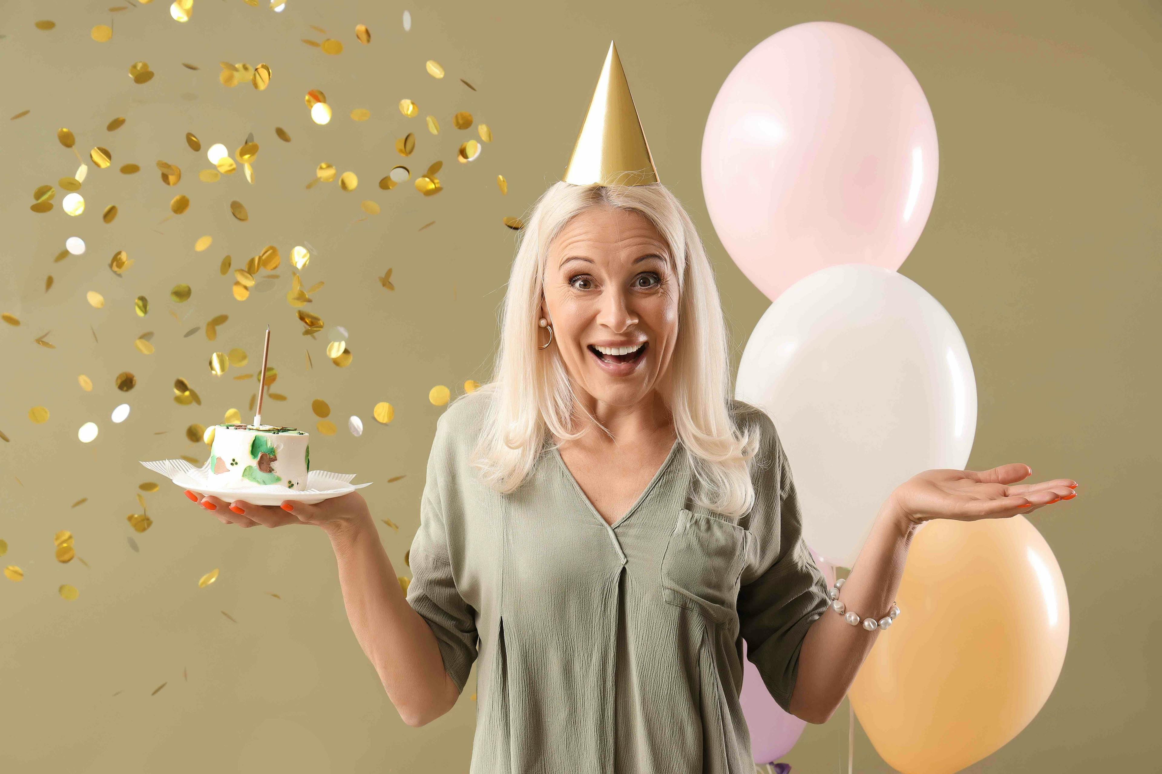 Mature woman birthday cake and balloons
