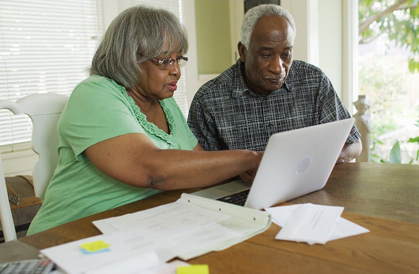 Man and woman looking at laptop