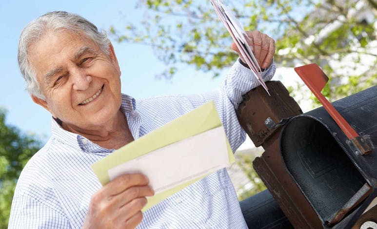 Man getting letter at mailbox