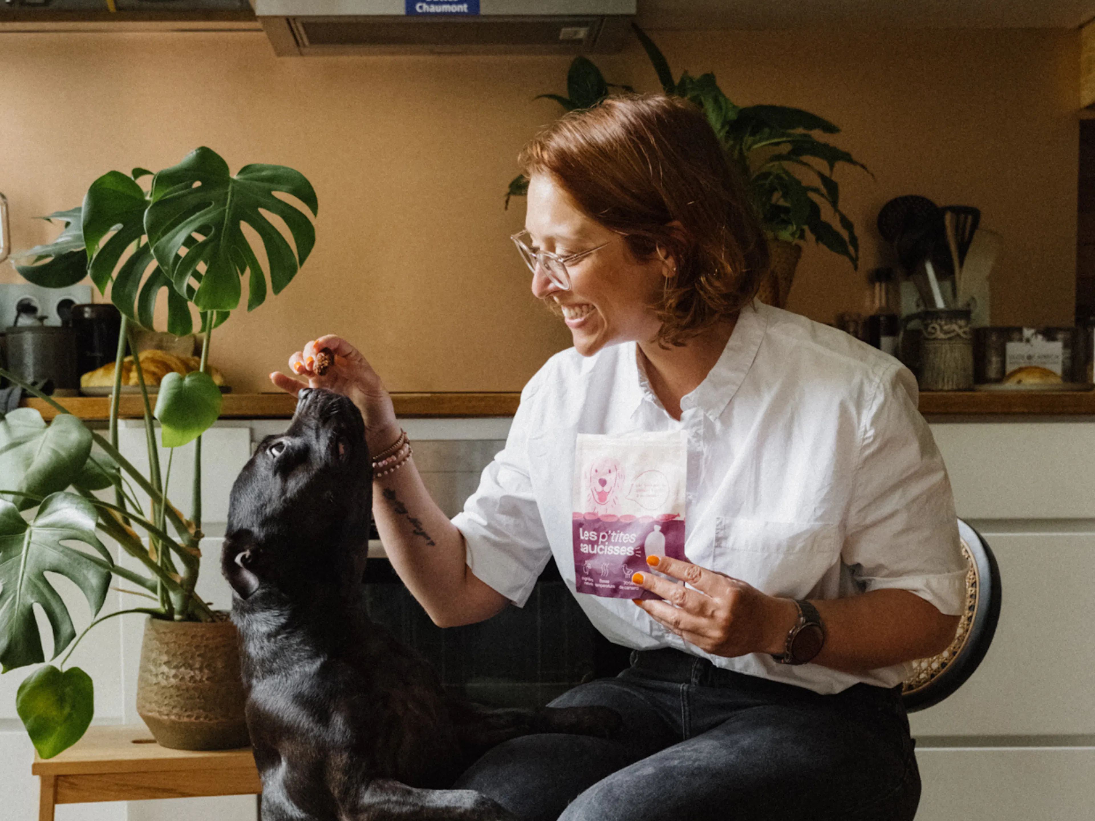 une femme donne une friandise à son chien
