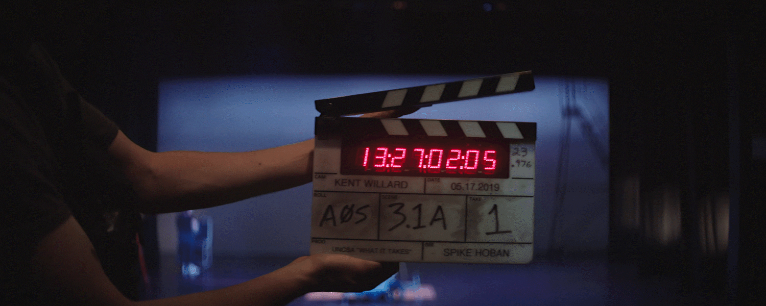 A clapperboard being used on set