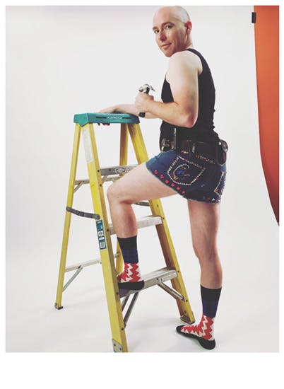 A man on a ladder at a video shoot for Stance Socks and bedazzled shorts